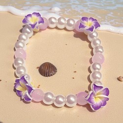 Purple plumeria and pearls give a peaceful vibe in a storm.