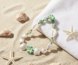 Green plumerias with seashells and white gems to give love to Mother Nature.